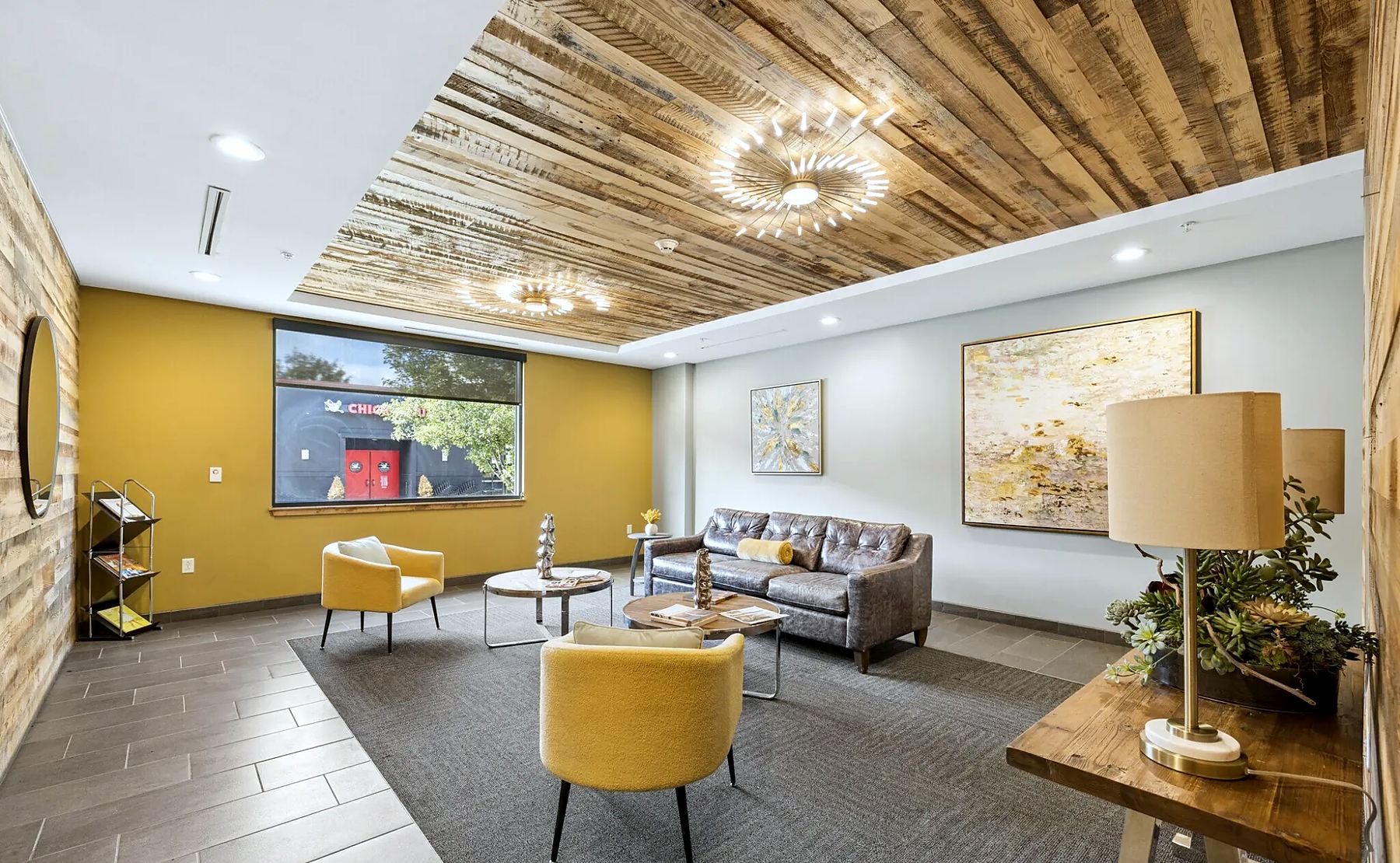 The leasing lounge at Charlotte Square, under a reclaimed wood ceiling