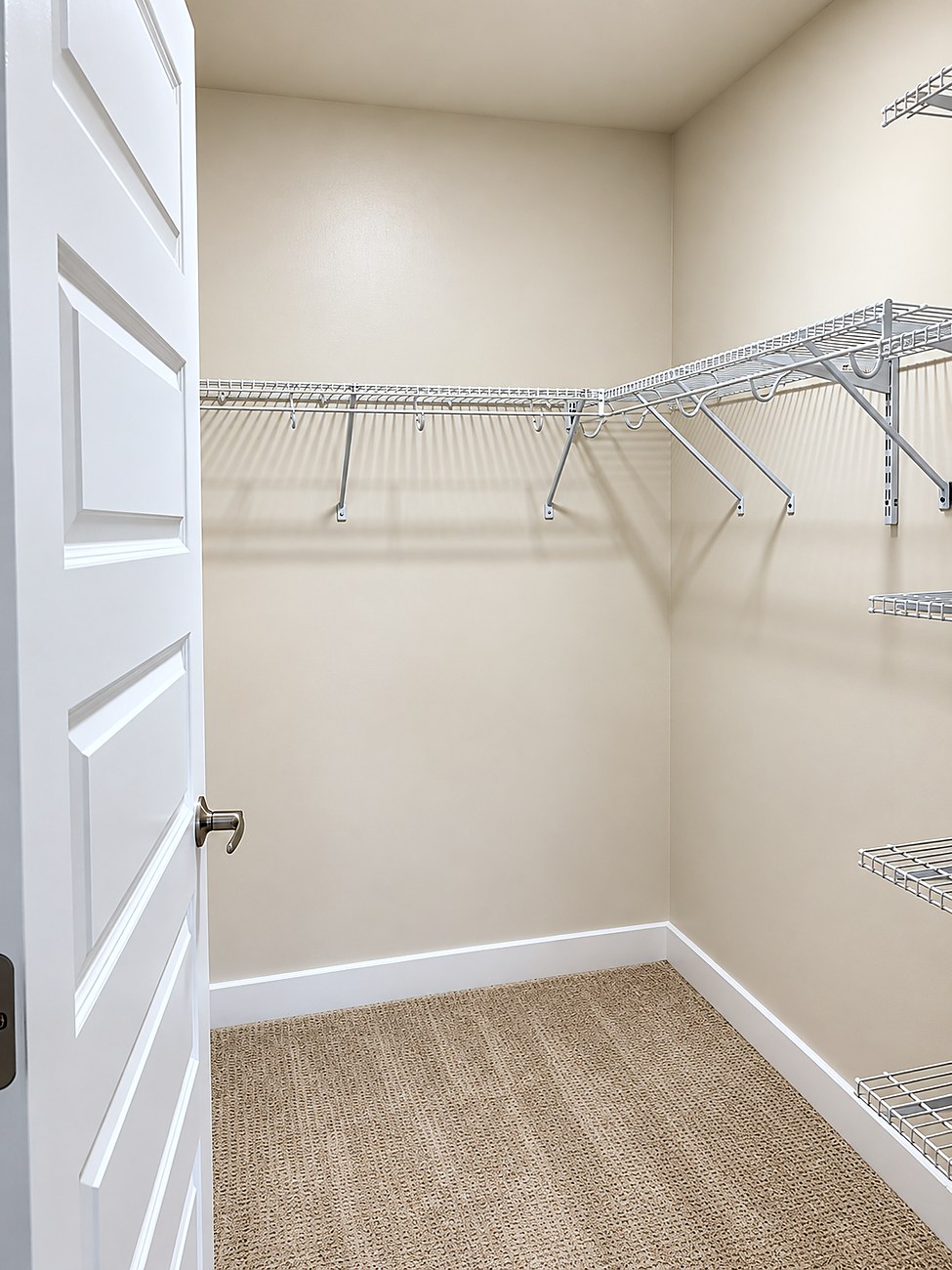 A walk-in closet at Charlotte Square with wire shelving on three walls