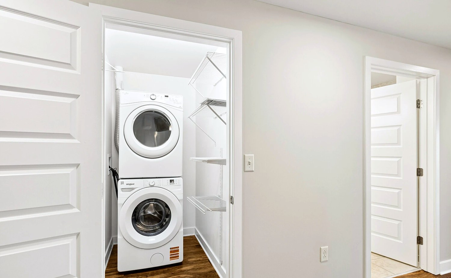 An in-home laundry closet at Charlotte Square with a stacked washer and dryer