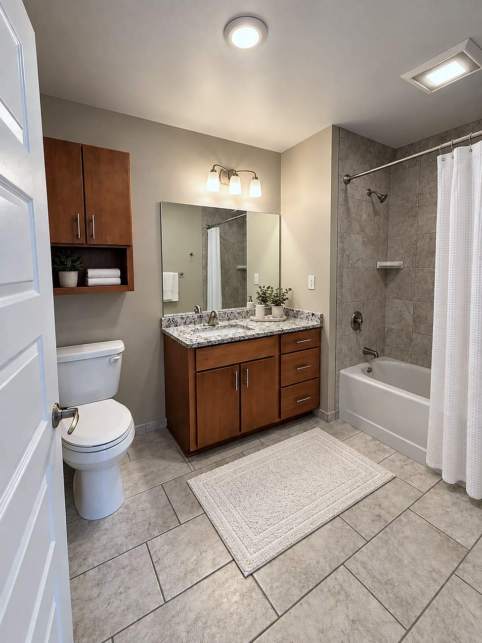 A bathroom at Charlotte Square, with an oak vanity, a stone counter and a tub-shower